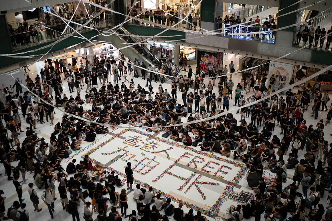 Residents gather at a shopping mall in Sha Tin to protest a teenage demonstrator shot at close range in the chest by a police officer.