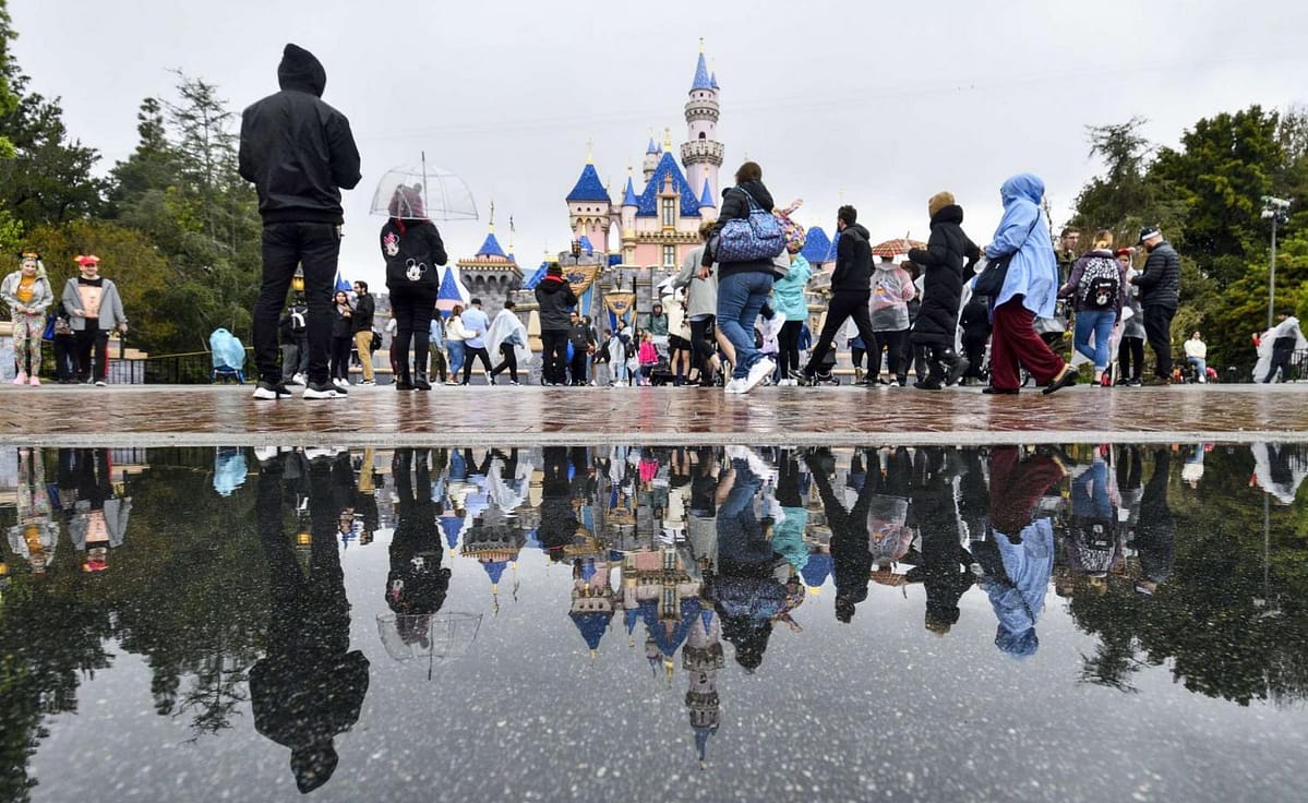 Visitors outside of the Sleeping Beauty Castle the day before Disneyland closed in March 2020.