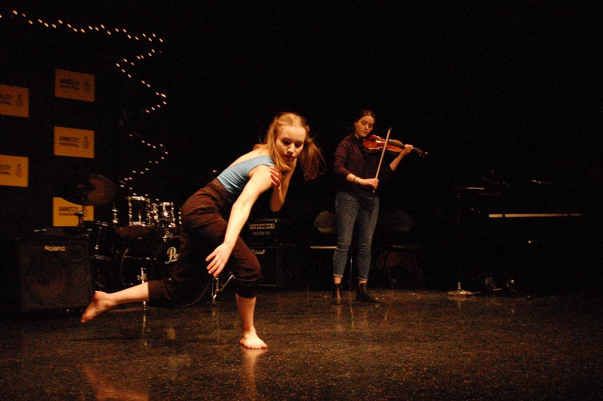 Julia Boberg '20 dances to her sister's violin accompaniment at Amnesty Coffeehouse.