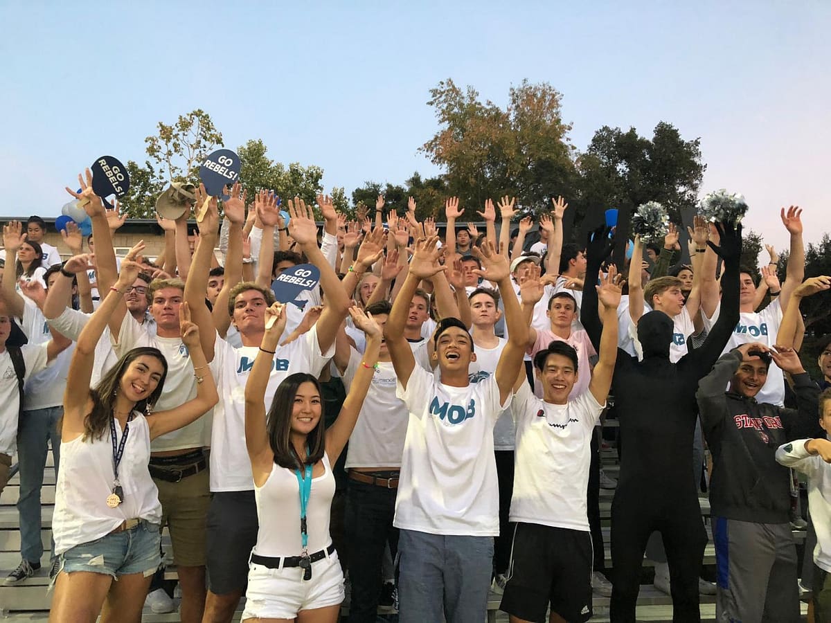 The MOB cheers on the Rebels' Football.