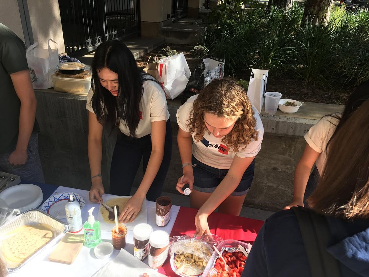 Chloe Chanren '19 and Katya Besch '20 make crepes for the crepe sale.